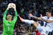Kasper Schmeichel of Denmark (L) in action agains Benjamin Sesko of Slovenia (R) during the 2024 UEFA European Champions