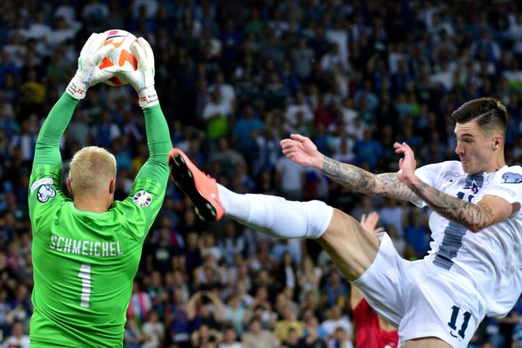 Kasper Schmeichel of Denmark (L) in action agains Benjamin Sesko of Slovenia (R) during the 2024 UEFA European Champions