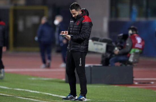 Ervin Bulku Assistant coach of Albania makes note on an electronic tablet at the half time interval of the FIFA World Cu